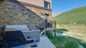 A stone building with a barbecue grill and outdoor seating. - Luxe Ski Escape! Breck Home w/ Hot Tub & Game Room (Blue River)