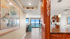 A spacious kitchen with a large island, wooden cabinets, and a view to the outside. - It Doesnt Get Any Better Than This! 2BR 2BA Sleeps 8 Beachfront! (Panama City Beach)