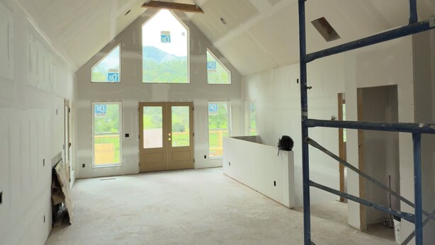 A spacious interior with high ceilings, large windows, and a visible skylight. - Pet-Friendly Luxury Home w/ Hot Tub and Mountain Views (Franklin)