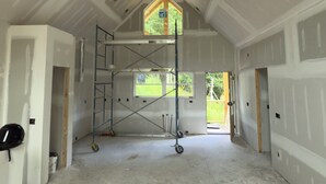A large, open interior space with high ceilings and exposed wooden beams. - Pet-Friendly Luxury Home w/ Hot Tub and Mountain Views (Franklin)