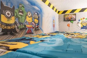 A bedroom with a bed, a wall mural, and a framed picture. - The Minions Mansion 6br Resort Pool Home By Disney (Kissimmee)