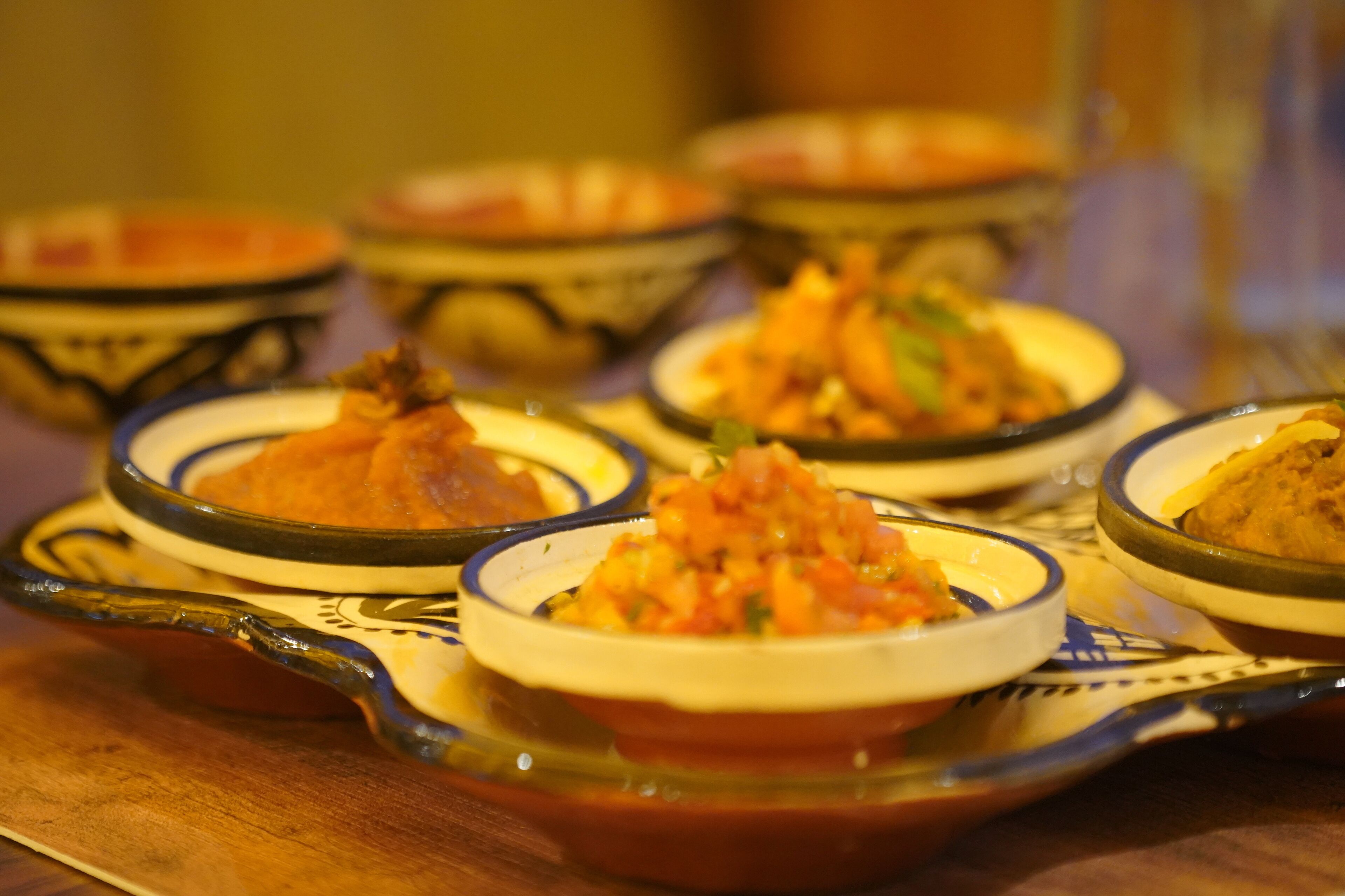 A table with various dishes in traditional serving bowls.