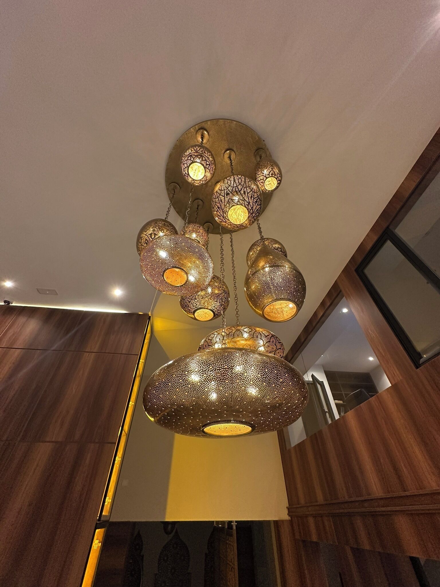A modern interior with a unique ceiling light fixture featuring multiple spherical designs.