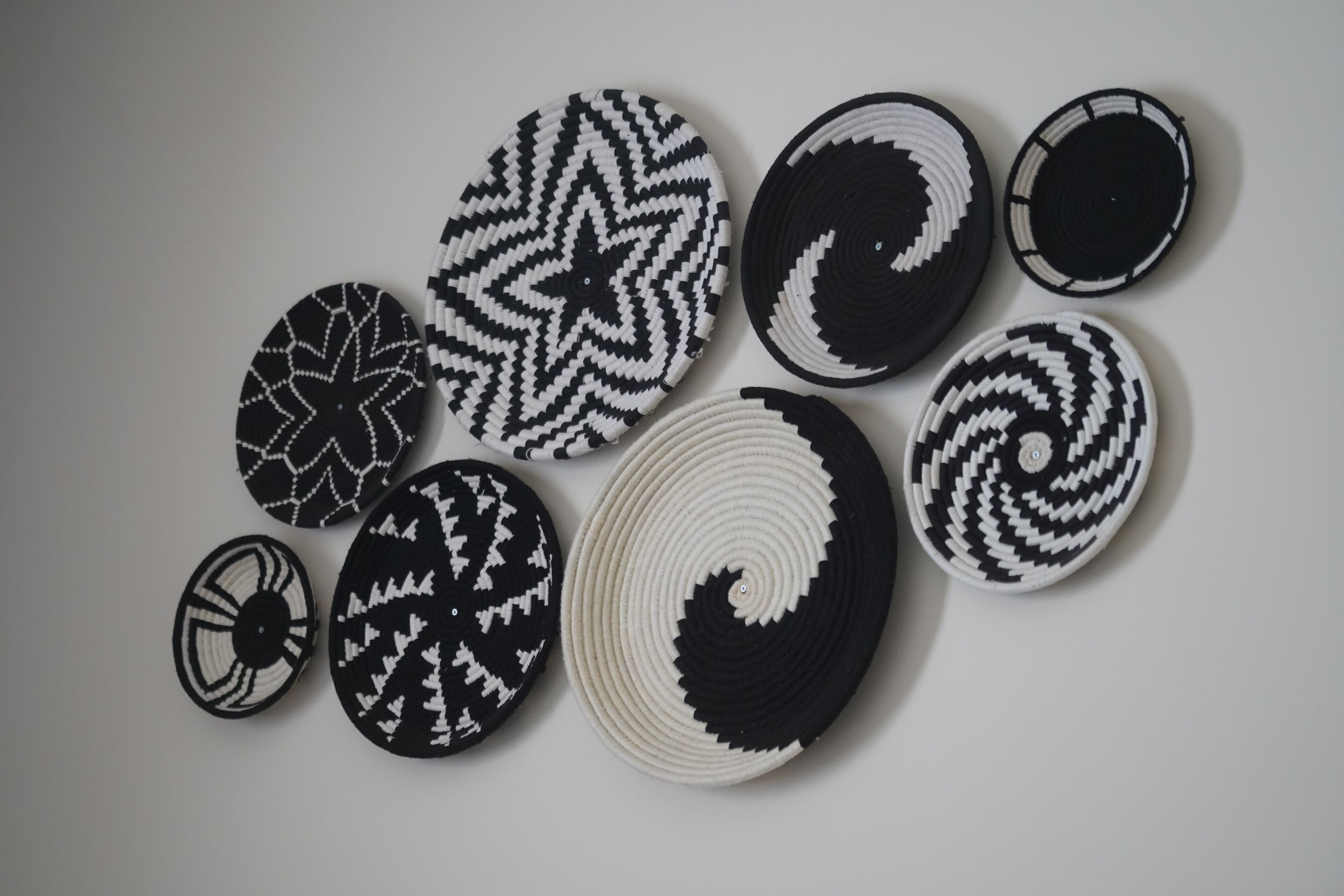 A collection of circular woven mats with various patterns.