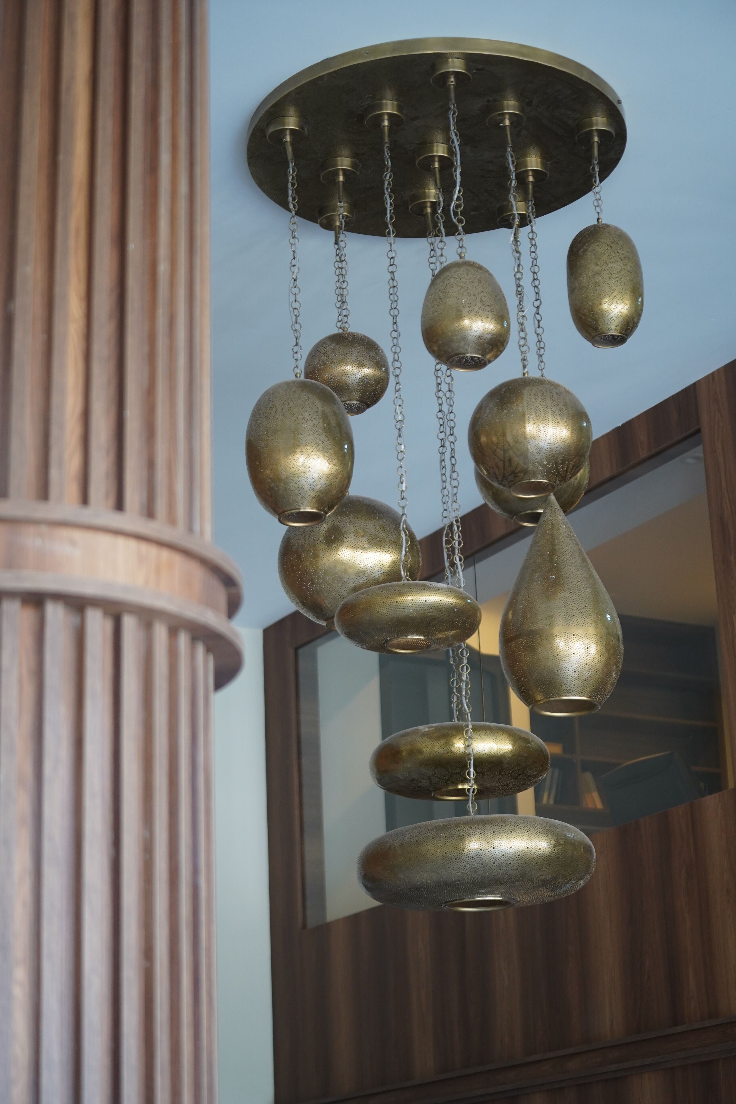 A ceiling with a decorative brass chandelier.