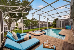 A covered outdoor pool area with lounge chairs and a hot tub. - The Magic Kingdom 9BR Resort Pool Home Near Disney (Four Corners)