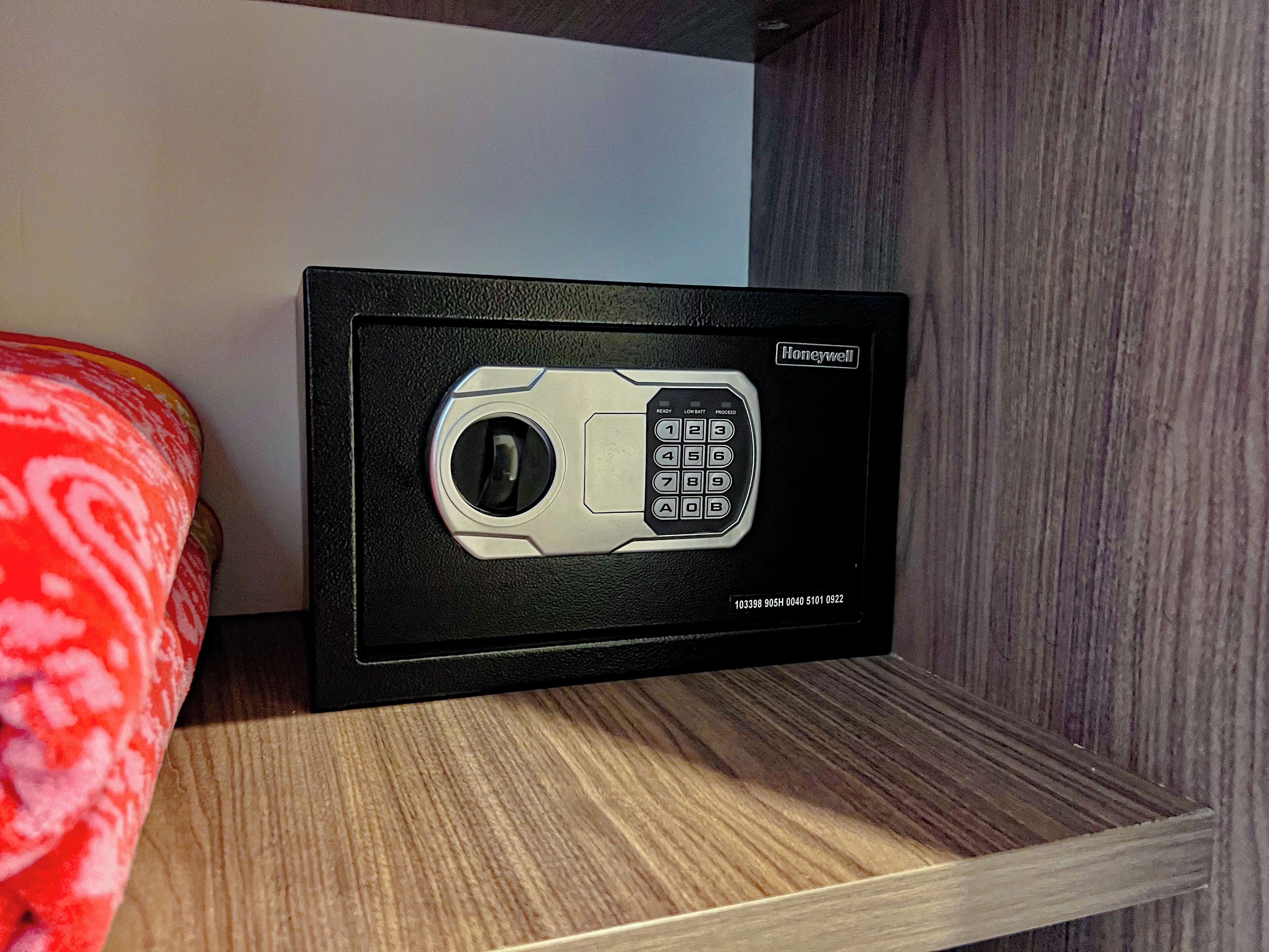 A Honeywell safe on a wooden shelf.