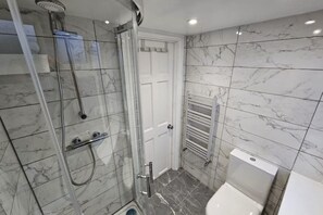 Shower, towels, soap, toilet paper
