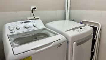 A front-loading washing machine and a dryer side by side in a laundry room.