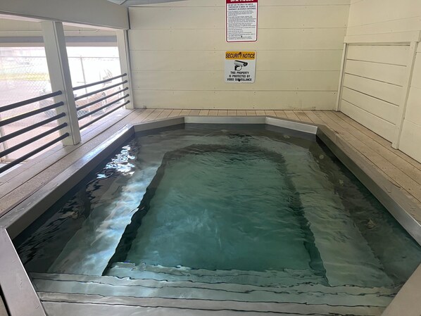 A spa area with a pool, a security notice, and a railing. - Dillon Valley East 2 Bed 2 Bath Dvjt (Dillon)