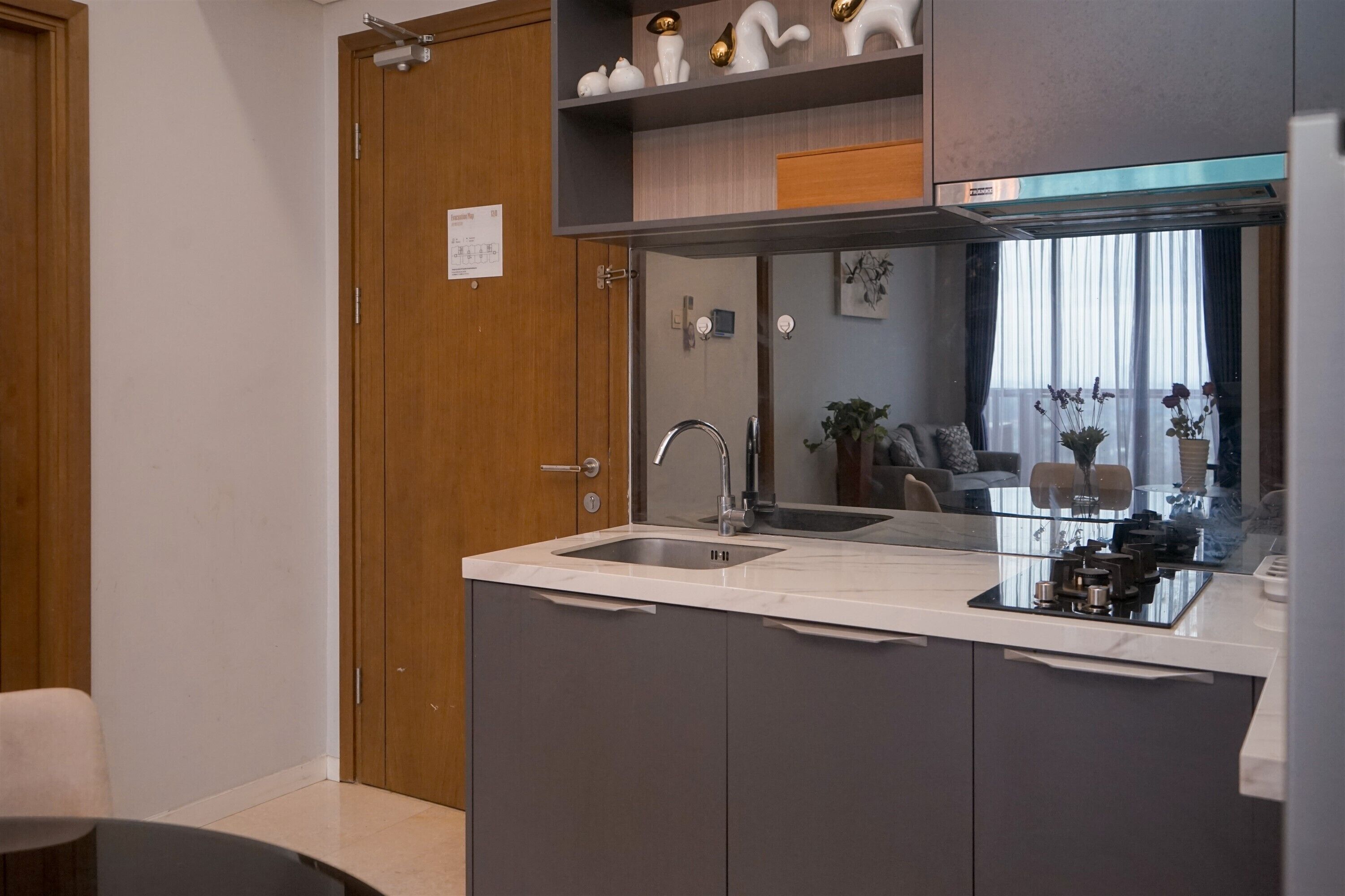 A modern kitchen with a built-in sink, a microwave, and a small island.