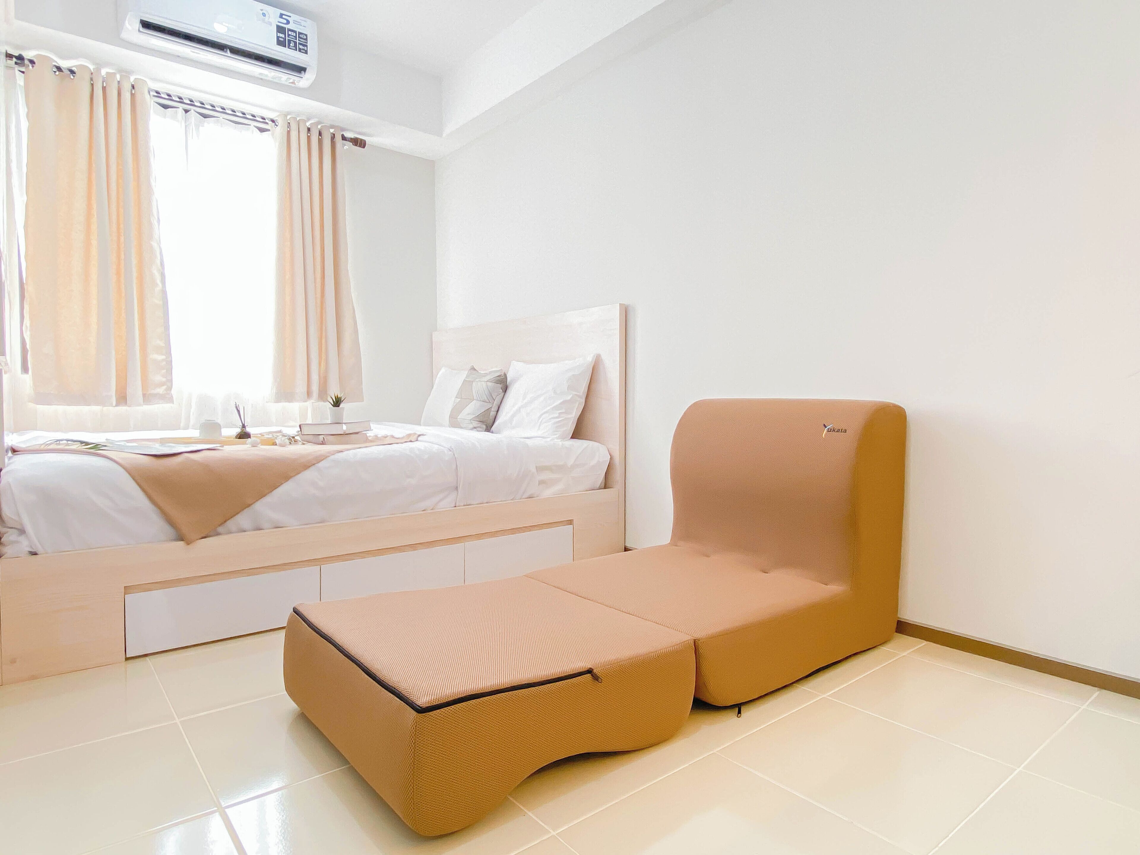 A modern bedroom with a bed, a sofa, and a small table.