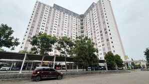 A multi-story residential building with a modern design, featuring balconies and a uniform facade. - Strategic 2Br Apartment Near Its Campus At Dian Regency (Surabaya)