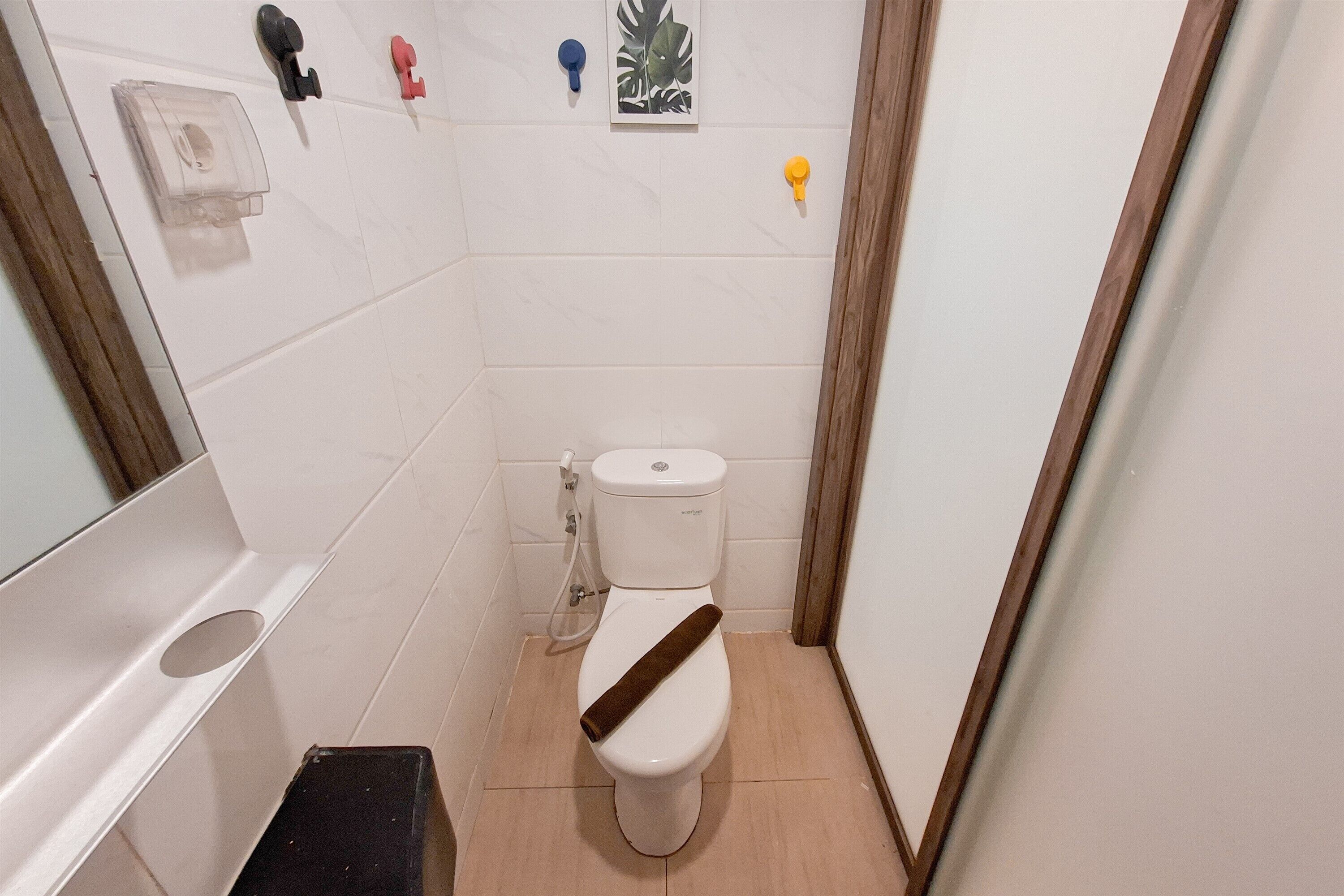 A small bathroom with a toilet, a sink, and a shower area.