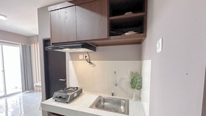 Eine moderne Küche mit Einbauherd, Spüle aus Edelstahl und Holzschränken.