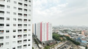 A high-rise building with multiple balconies and a view of a cityscape. - Compact 2Br Apartment Near Unj At Green Pramuka City (Jakarta)