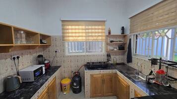 Fridge, microwave, stovetop, coffee/tea maker