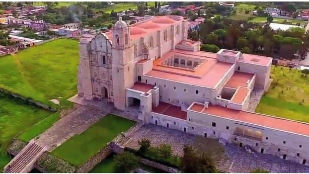 An aerial view of a large, historic building with a prominent bell tower and a central courtyard. - Single Apartment Ara (Santo Domingo Yanhuitlán)