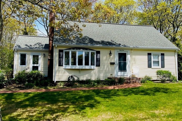 Front yard has water views and space for lawn games.