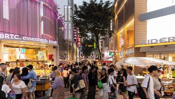 A busy urban street with various shops and pedestrians.