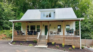 A two-story house with a porch, wooden deck, and a small garden area. - Pickle/Basketball, Gym, Rockwall, Arcade, Hot Tub! (Lumpkin County)