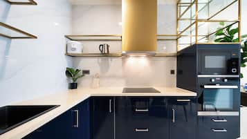 Apartamento superior, 2 quartos, sacada, vista para a cidade | Cozinha compartilhada | Geladeira, micro-ondas, cooktop, talheres/pratos/utensílios de cozinha
