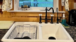 A kitchen with a window, a sink, and a coffee maker.