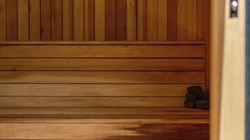 A wooden sauna with benches and stones.