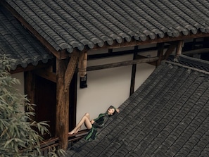 A traditional building with a sloped roof and wooden beams.