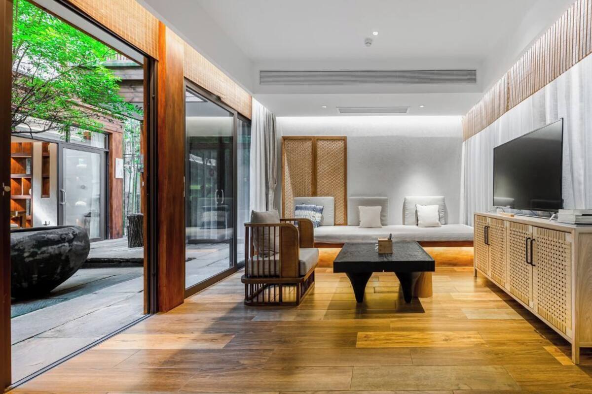 A modern living room with a sofa, coffee table, and TV.