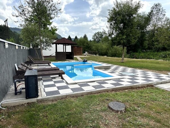 Seasonal outdoor pool, pool umbrellas, pool loungers