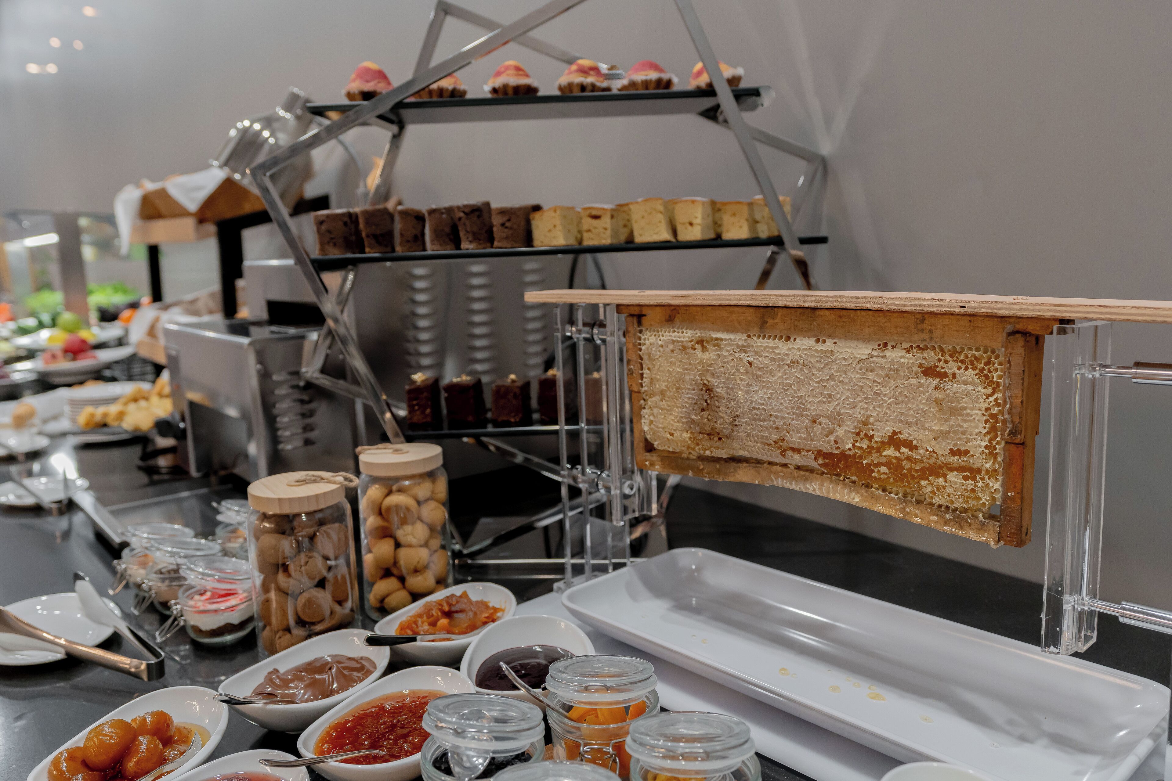 A buffet with various food items and a honeycomb display.