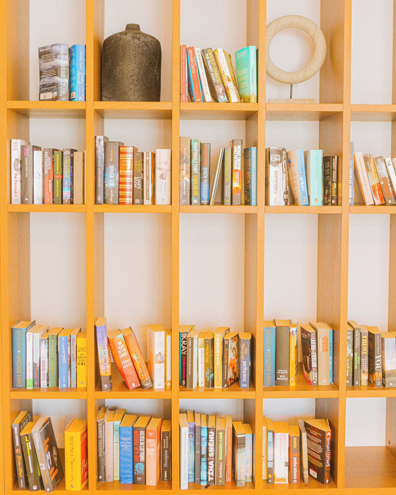 A bookshelf with various books and decorative items.