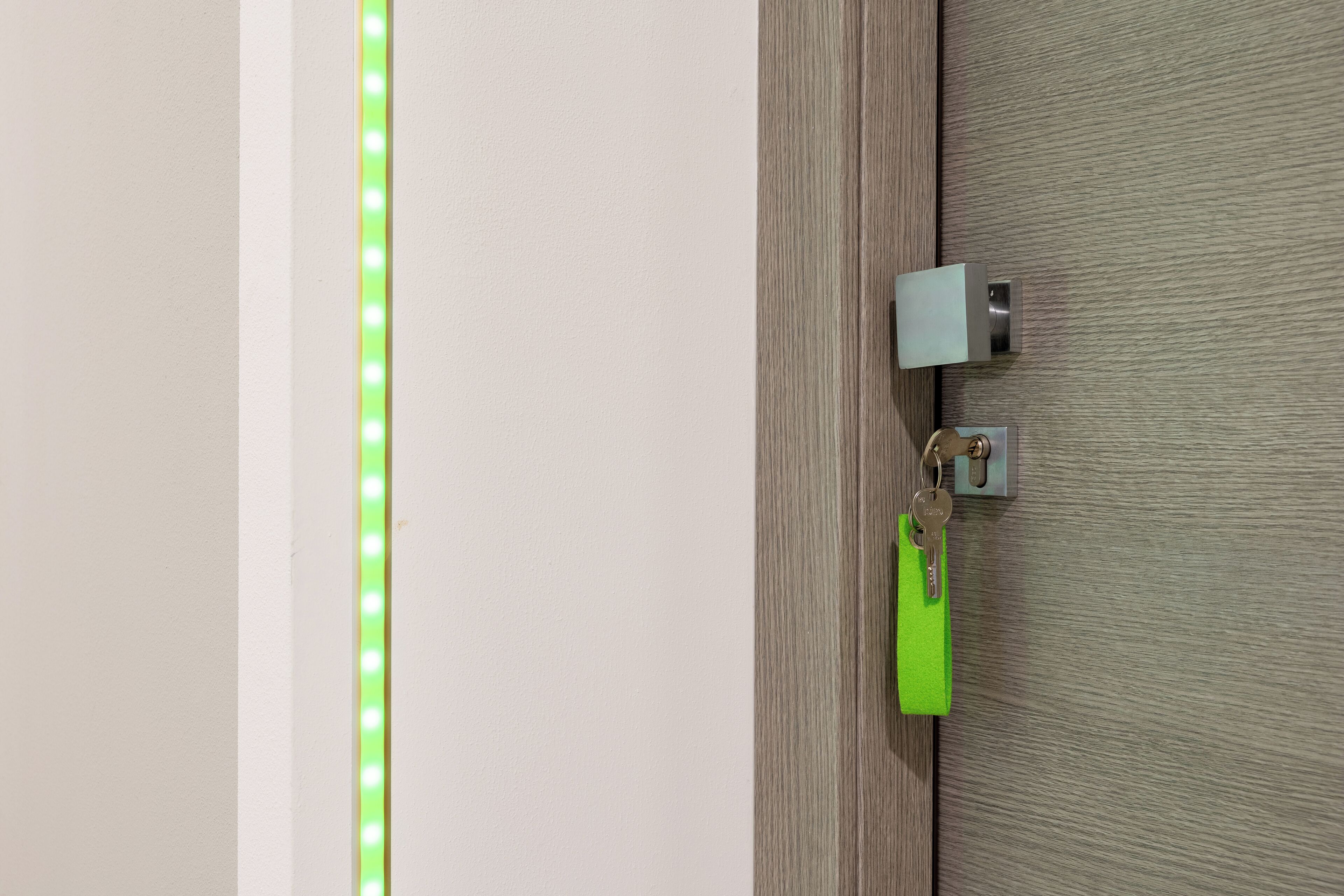 A door with a keyhole and a keychain.