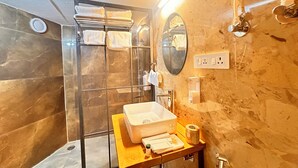A modern bathroom with a glass shower enclosure, a large mirror, and a wooden vanity with a sink and storage. - Nestonature Glamping Dharamshala (Dharamshala)