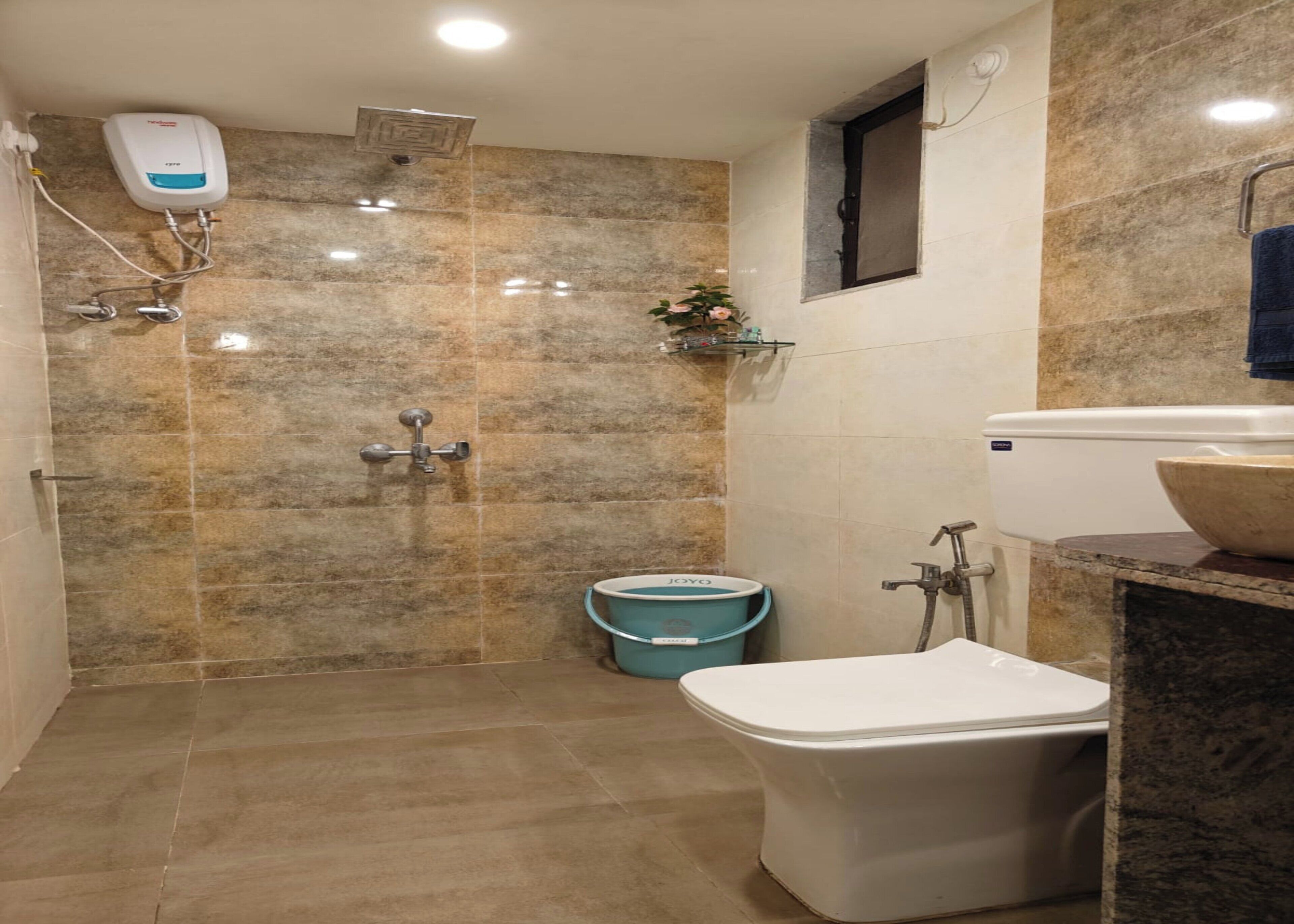 A bathroom with a shower, toilet, and sink.