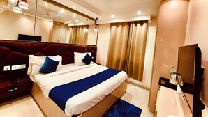 Une chambre d’hôtel moderne dotée d’un grand lit, d’une télévision à écran plat, d’un bureau et d’une salle de bain.