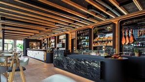 Un espace bar moderne avec des poutres en bois, des comptoirs en marbre et des sièges.