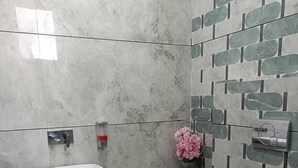 A modern bathroom with a white sink, a toilet, and a shower. - Hotel Kamboj (Kharar)