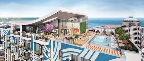 Un hôtel moderne doté d’une piscine sur le toit, d’un espace extérieur aménagé et offrant une vue sur la mer.