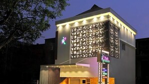 A modern hotel with a distinctive facade featuring a geometric pattern of lights. - PARK RESIDENCY KODUNGALLUR (Kodungallur)