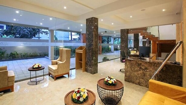 A spacious lobby with a marble floor, seating areas, and a reception desk. - PARK RESIDENCY KODUNGALLUR (Kodungallur)
