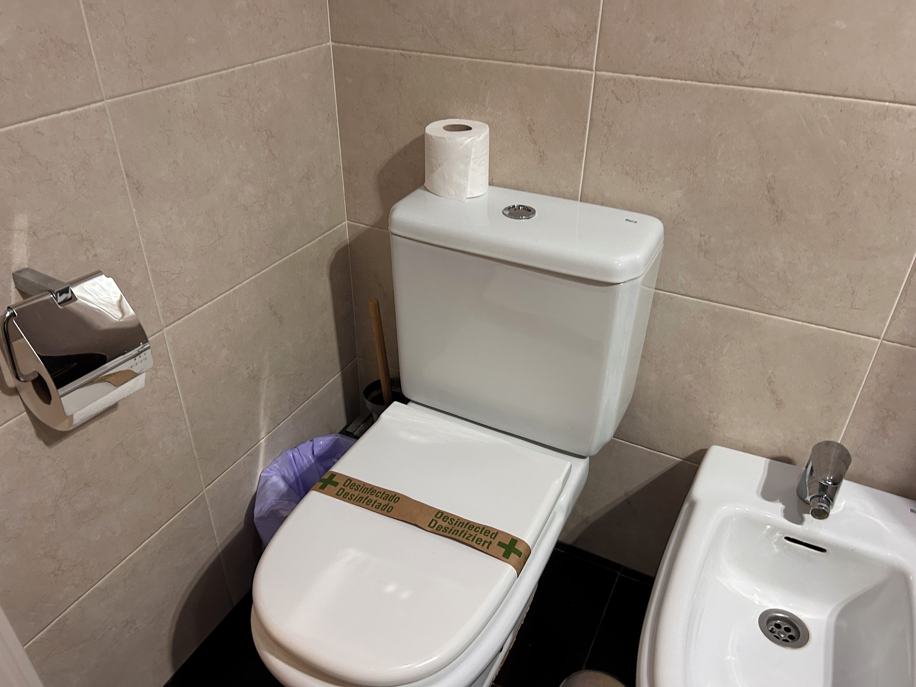 Une salle de bain comprenant des toilettes, un bidet et un lavabo.