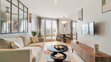 Deluxe Penthouse, City View | Living area | Smart TV