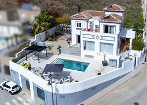 A modern two-story house with a swimming pool, outdoor seating, and a car parked nearby. - Villa 'La Buena Vida Torrox' with Sea View, Wi-Fi and Air Conditioning (Torrox)