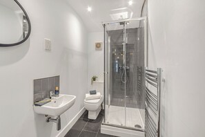 Shower, hair dryer, towels, toilet paper