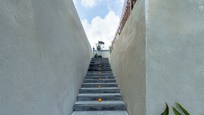 A narrow staircase with a checkered pattern leading up to a building. - Mahayani Ubud Villa (Tegallalang)