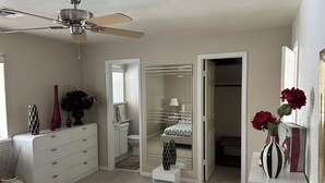 A bedroom with a bed, dresser, vanity, and a walk-in closet. - Charming, very quiet house (Lake Havasu City)