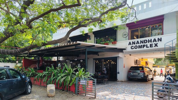 A building with a sign reading "ANANDHAN COMPLEX". - Dhanas Residency Auroville (Kuilapalayam)