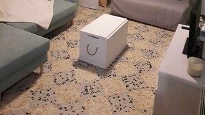 A living room with two sofas, a coffee table, a cabinet with items, and a door leading to another room. - T2 in charming Ardèchois village (SAINT-JULIEN-EN-SAINT-ALBAN)